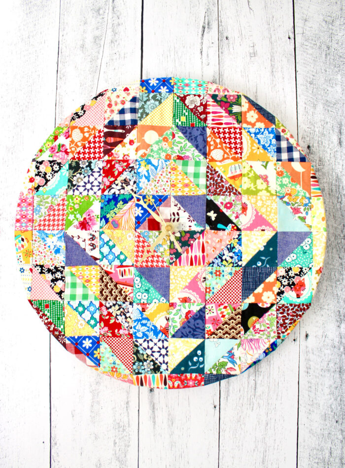 clock made from a variety of fabric scraps on wood table