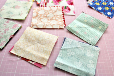 fabric squares on pink cutting mat