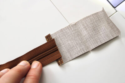 zipper end on brown fabric
