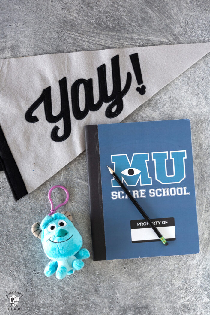 blue notebook on gray table with school supplies