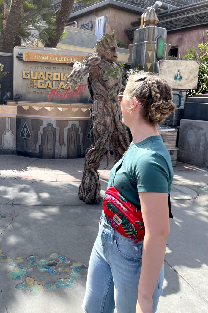 Girl with braids in front of Groot at Disneyland