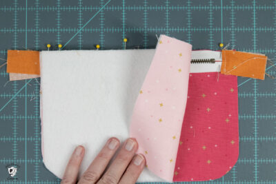 2 layers of fabric and zipper on cutting mat