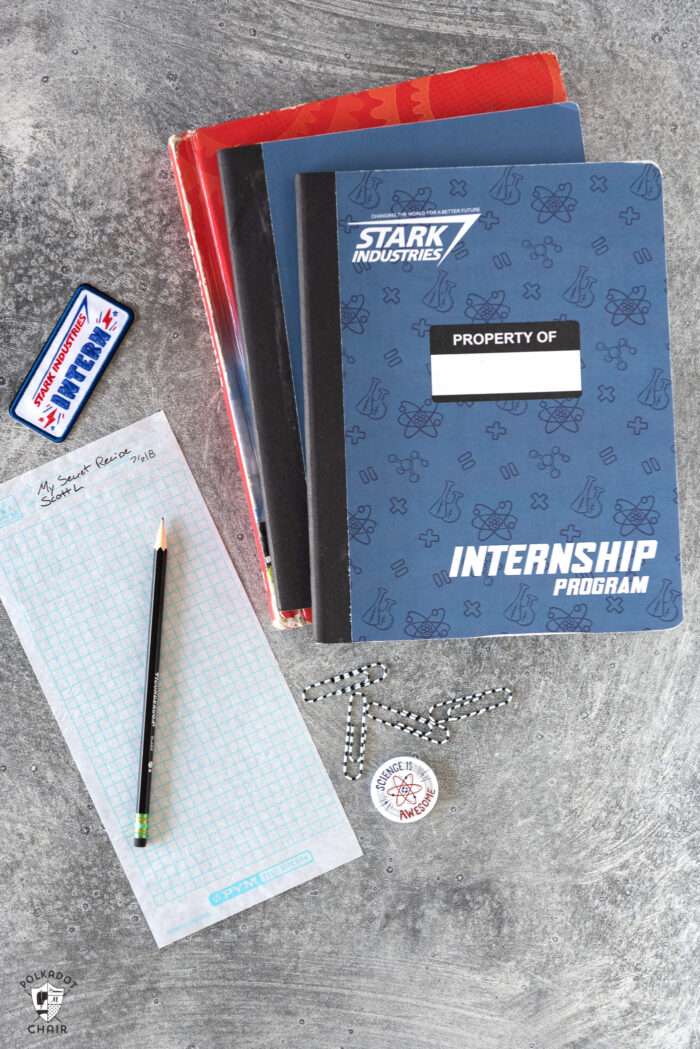 blue notebook on gray table with school supplies