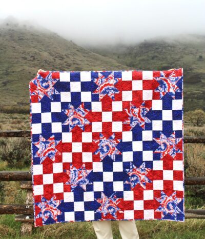 red white and blue geometric quilt outdoors