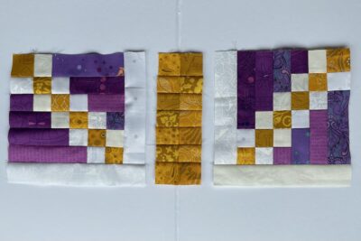 Gold and purple quilted pillow on wood table