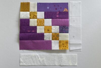 purple and white and gold fabrics on white table