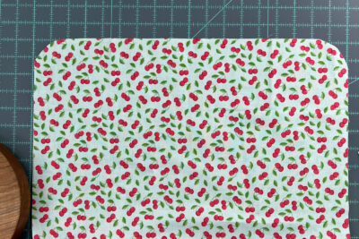 cherry fabric on blue cutting mat