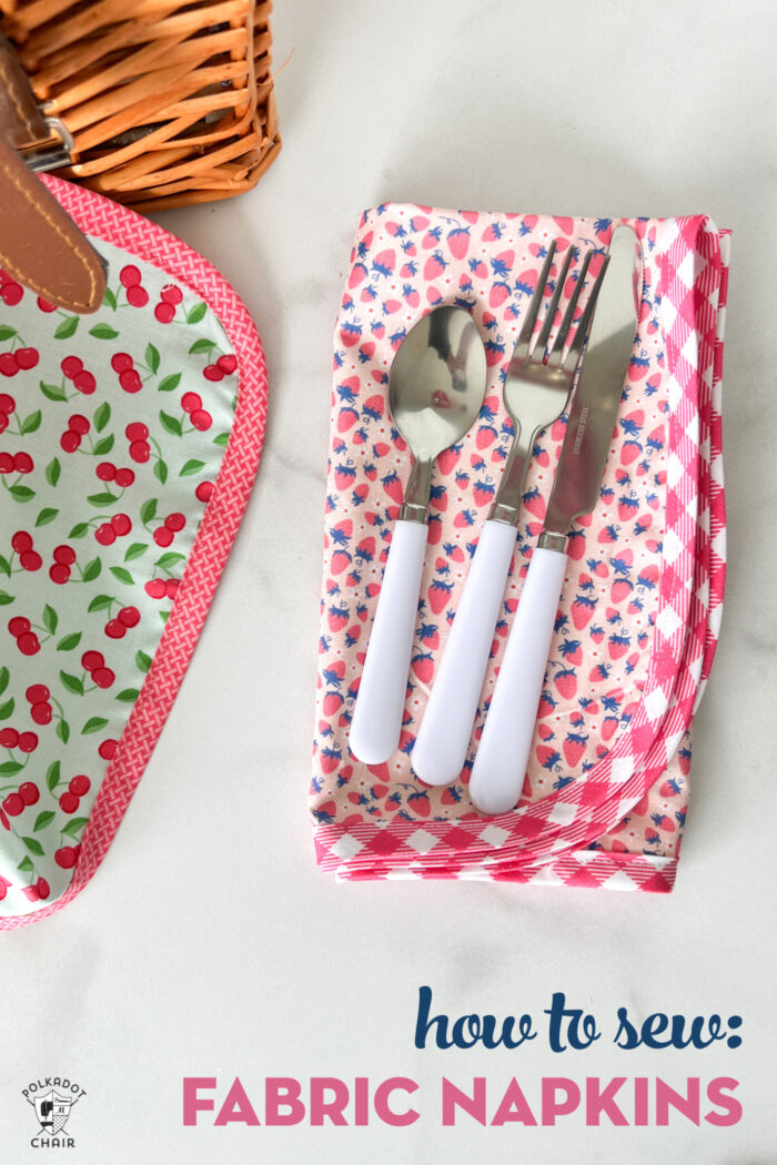 Pink fabric napkin with utensils on white marble table