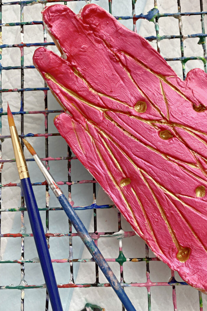 close up of pink pin dish with botanical detials