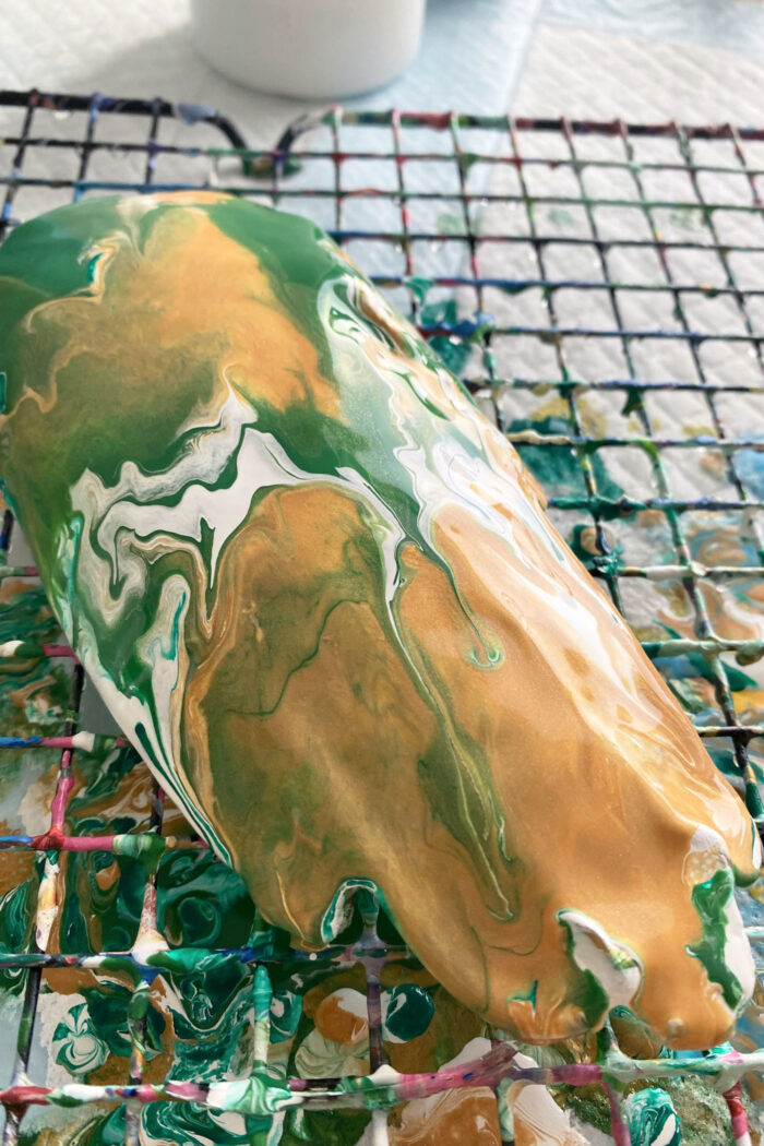 green and gold paint poured over dish