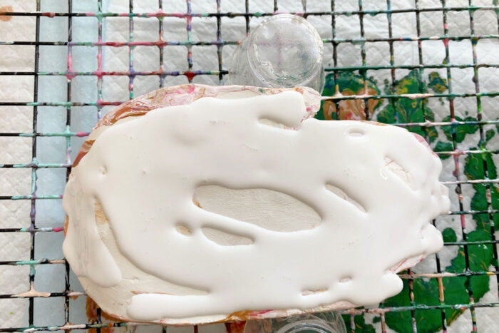 white paint poured over dish on wire rack