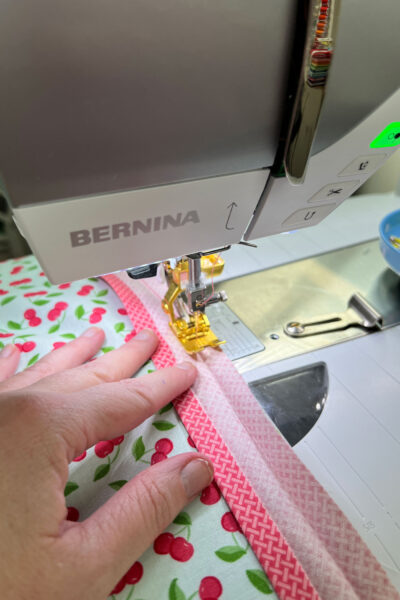 blue cherry fabric under foot of sewing machine