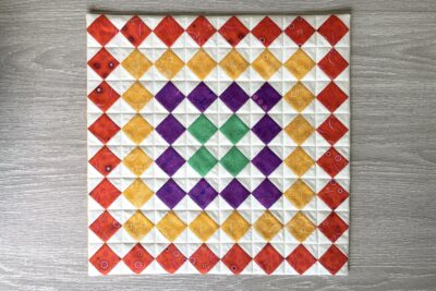 colorful pieced quilt block in red, yellow, green and purple