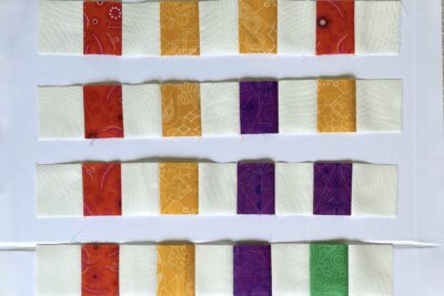 squares of yellow, purple, green and red fabric