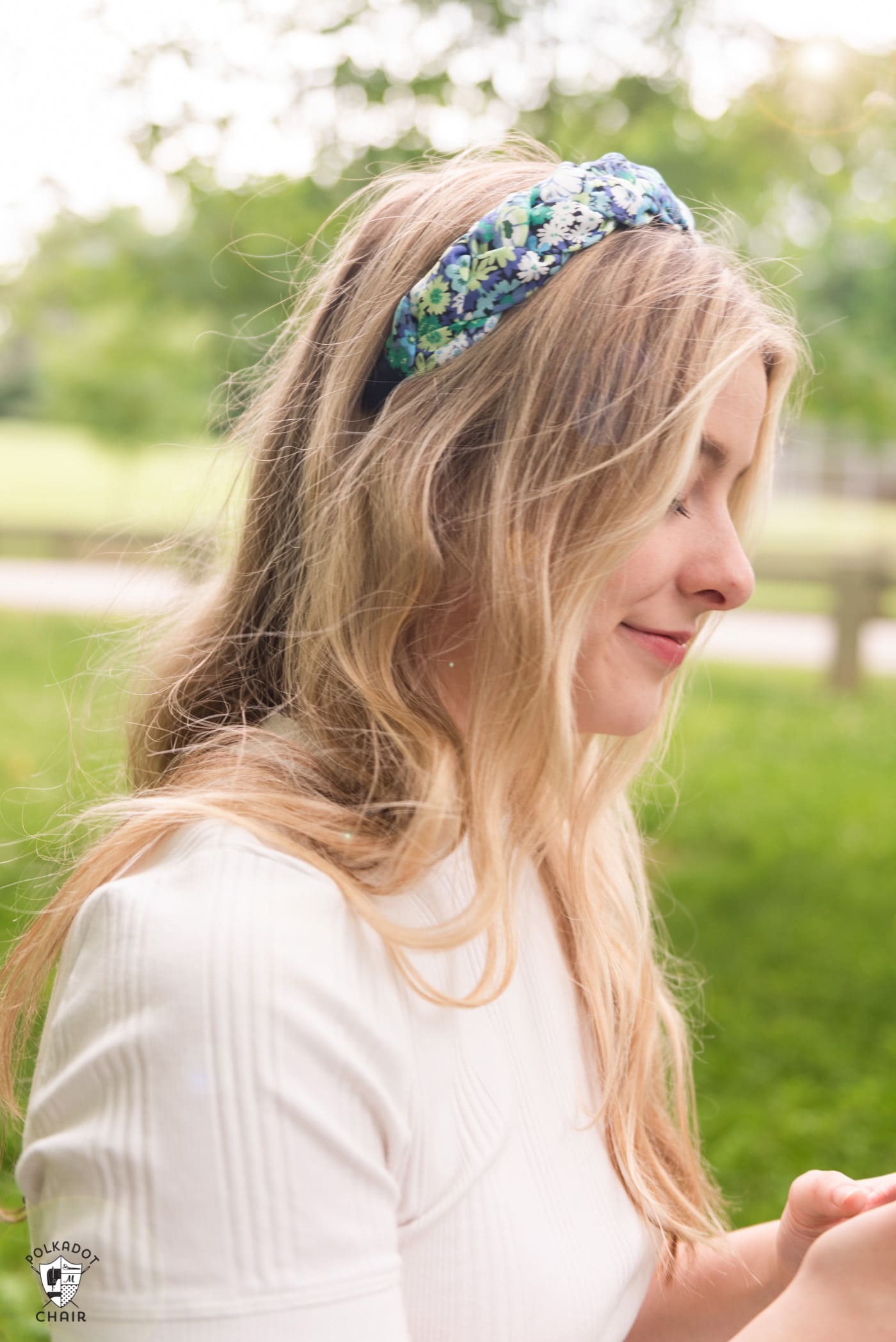 profile view of girl wearing headband outdoors
