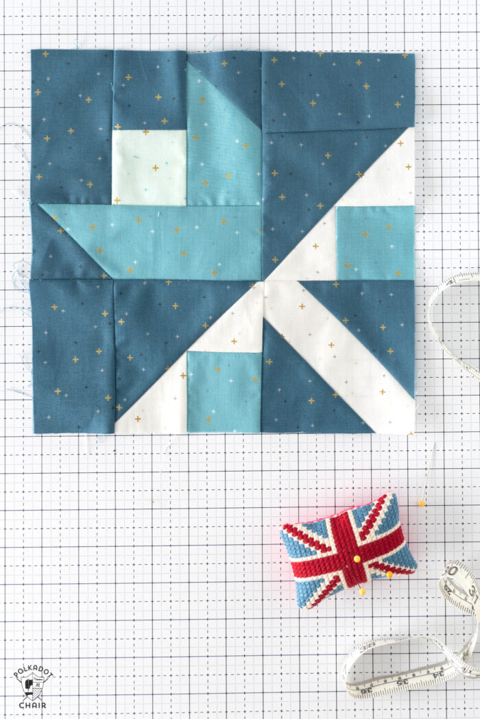 aqua, blue and green quilt block on white cutting mat with notions