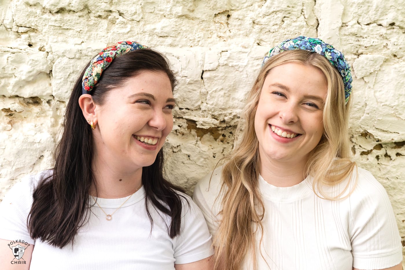 two girls wearing white shirts and colorful braided headbands