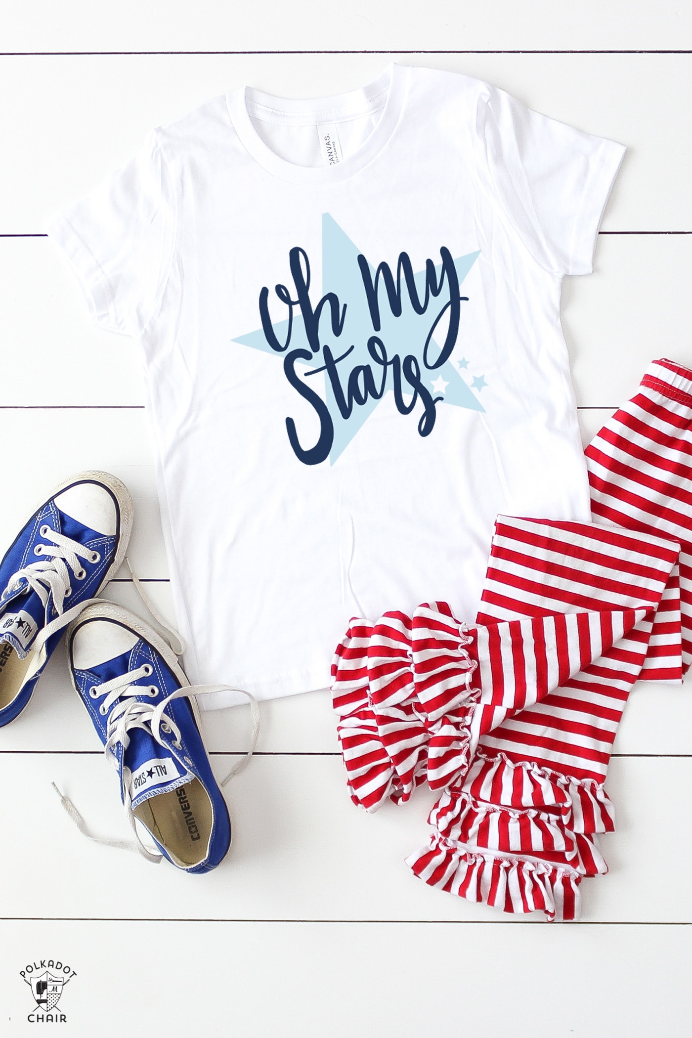 White tshirt, blue shoes and red white pants on white wood table