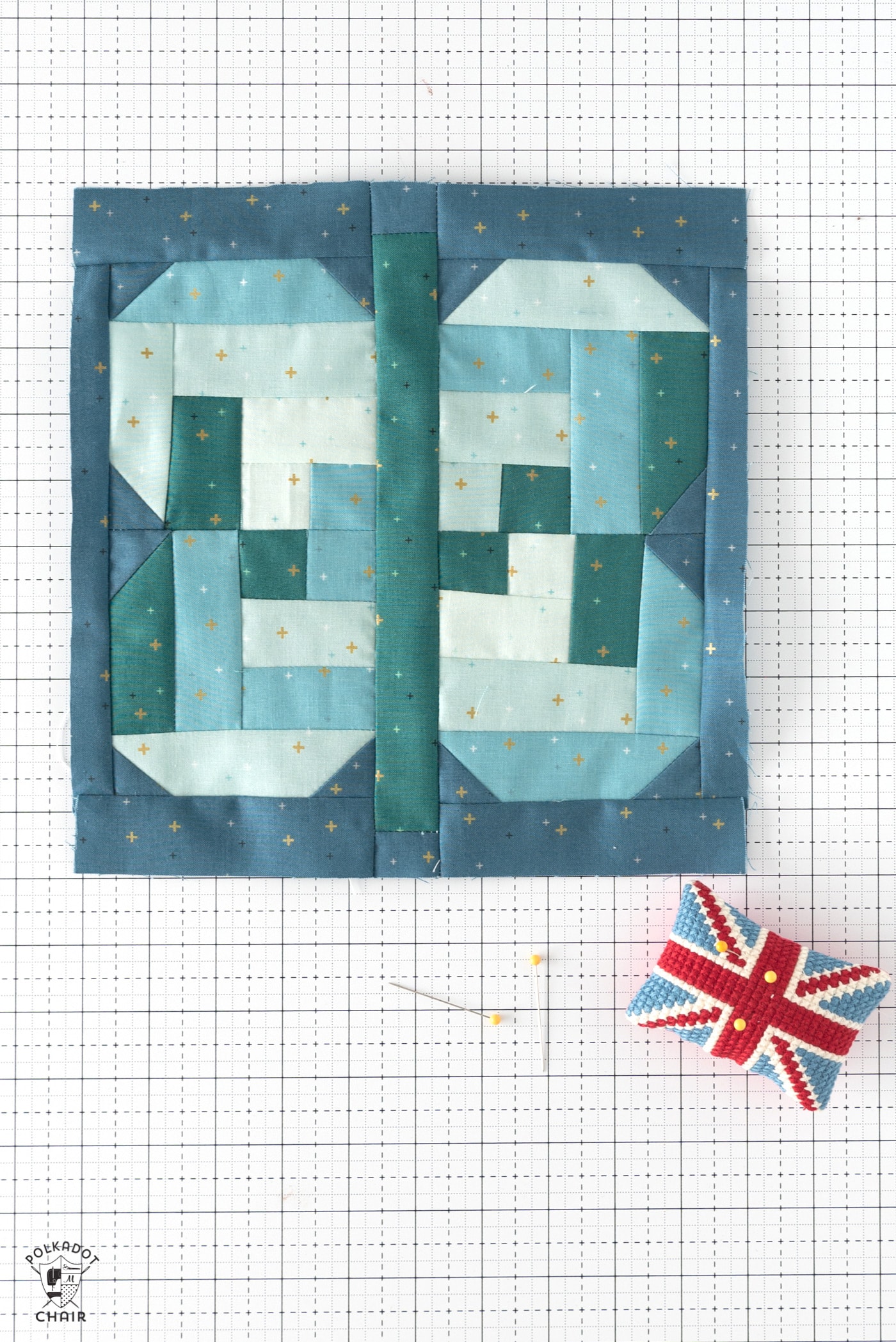 aqua, blue and green quilt block on white cutting mat with notions