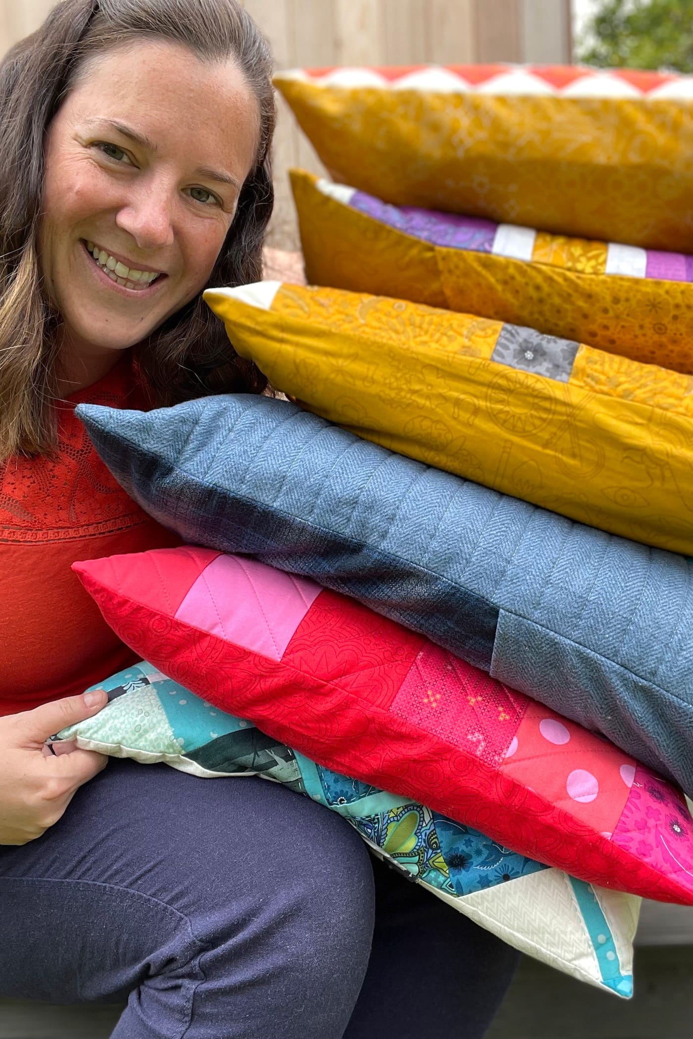 woman next to stack of pillows