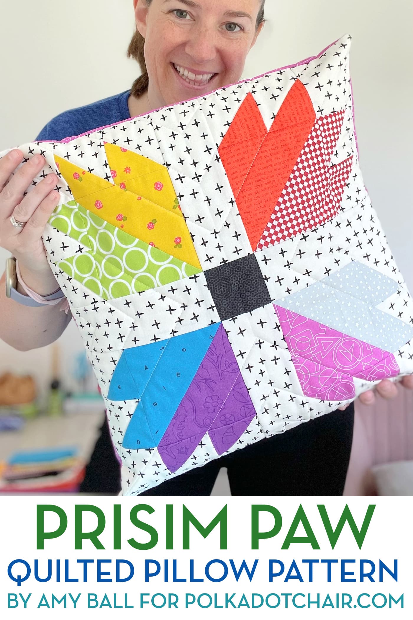 woman holding colorful quilted pillow pattern