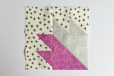 quilt block made from pink and gray fabric