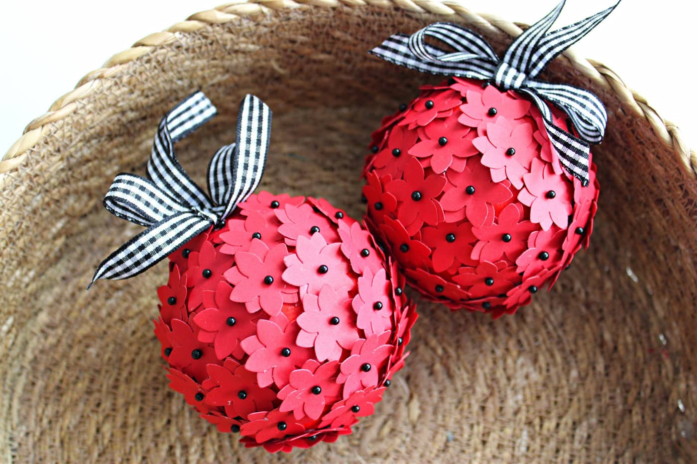 red and black christmas ornament in straw basket