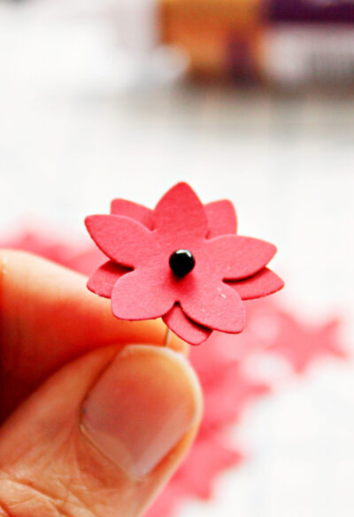 black pin in center of red flowers