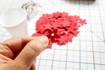 White glue on red paper flower