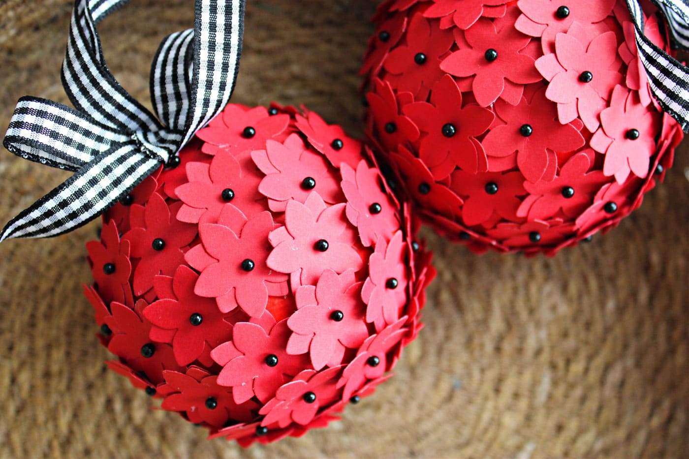 red and black christmas ornament in straw basket