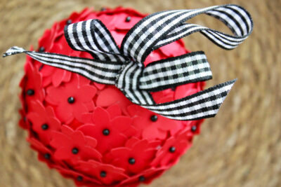 red and black christmas ornament in straw basket