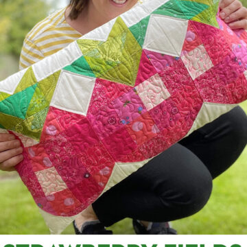 woman holding strawberry patchwork pillow outdoors