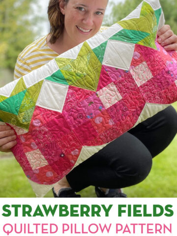 woman holding strawberry patchwork pillow outdoors