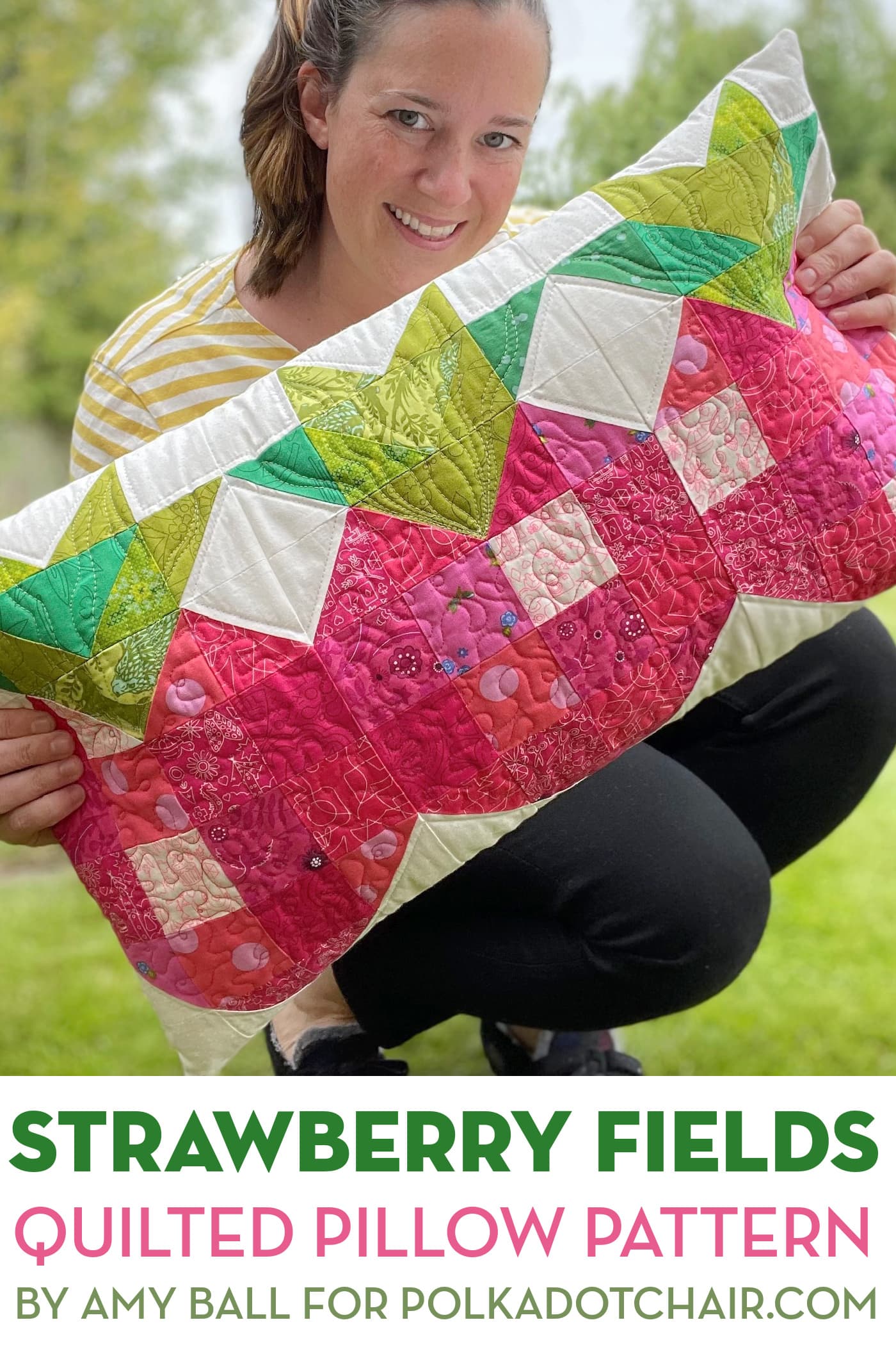 woman holding strawberry patchwork pillow outdoors
