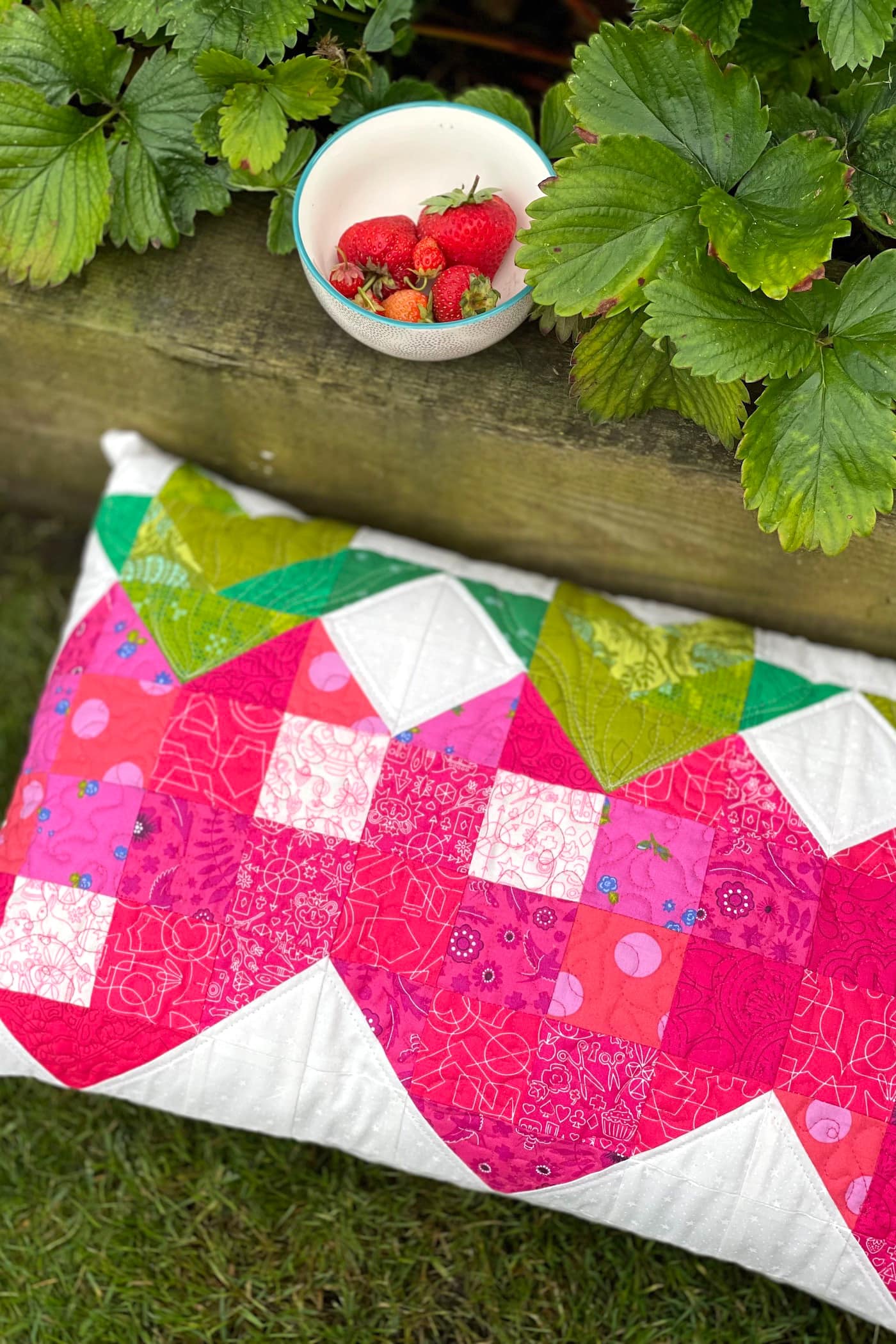 quilted strawberry patchwork pillow outdoors