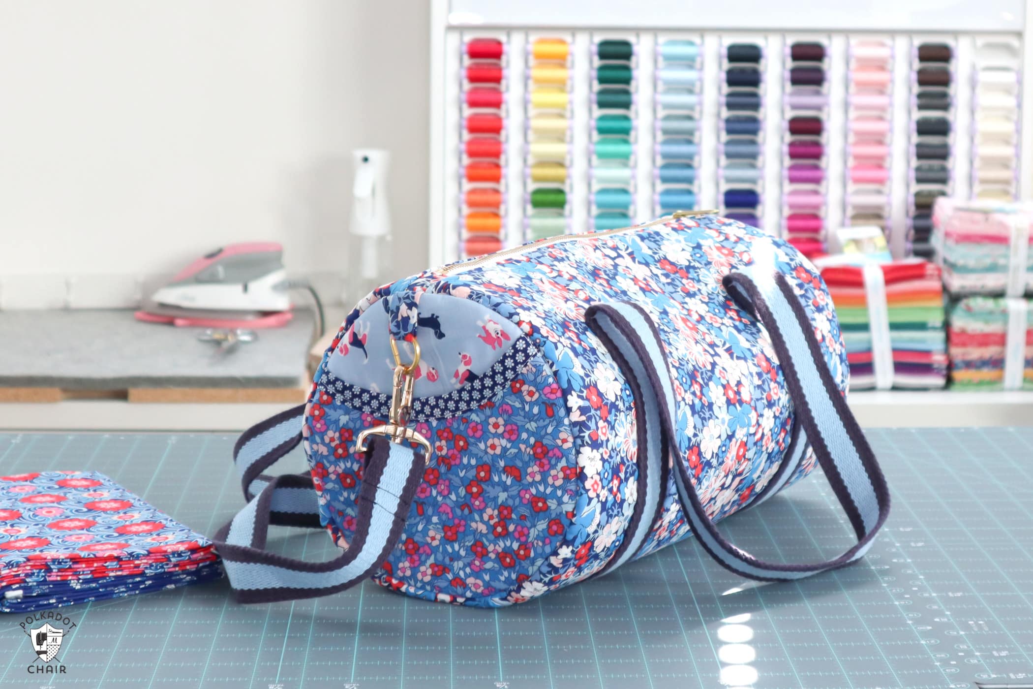blue duffle bag on table in front of thread rack
