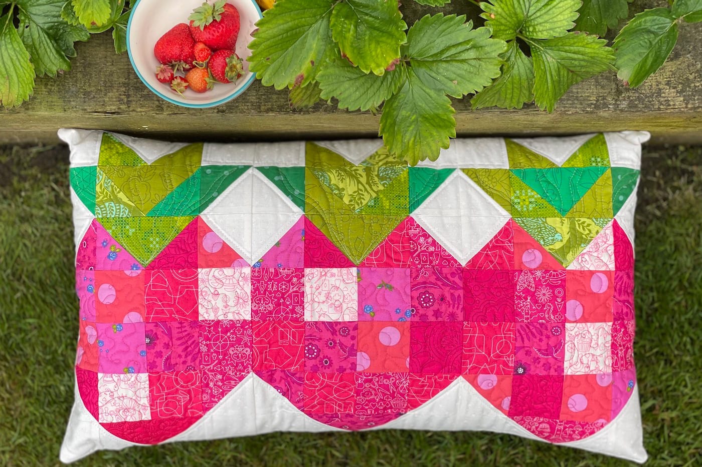 quilted strawberry patchwork pillow outdoors