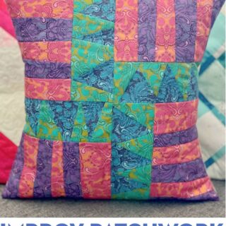 Blue, green, purple and red patchwork pillow on couch