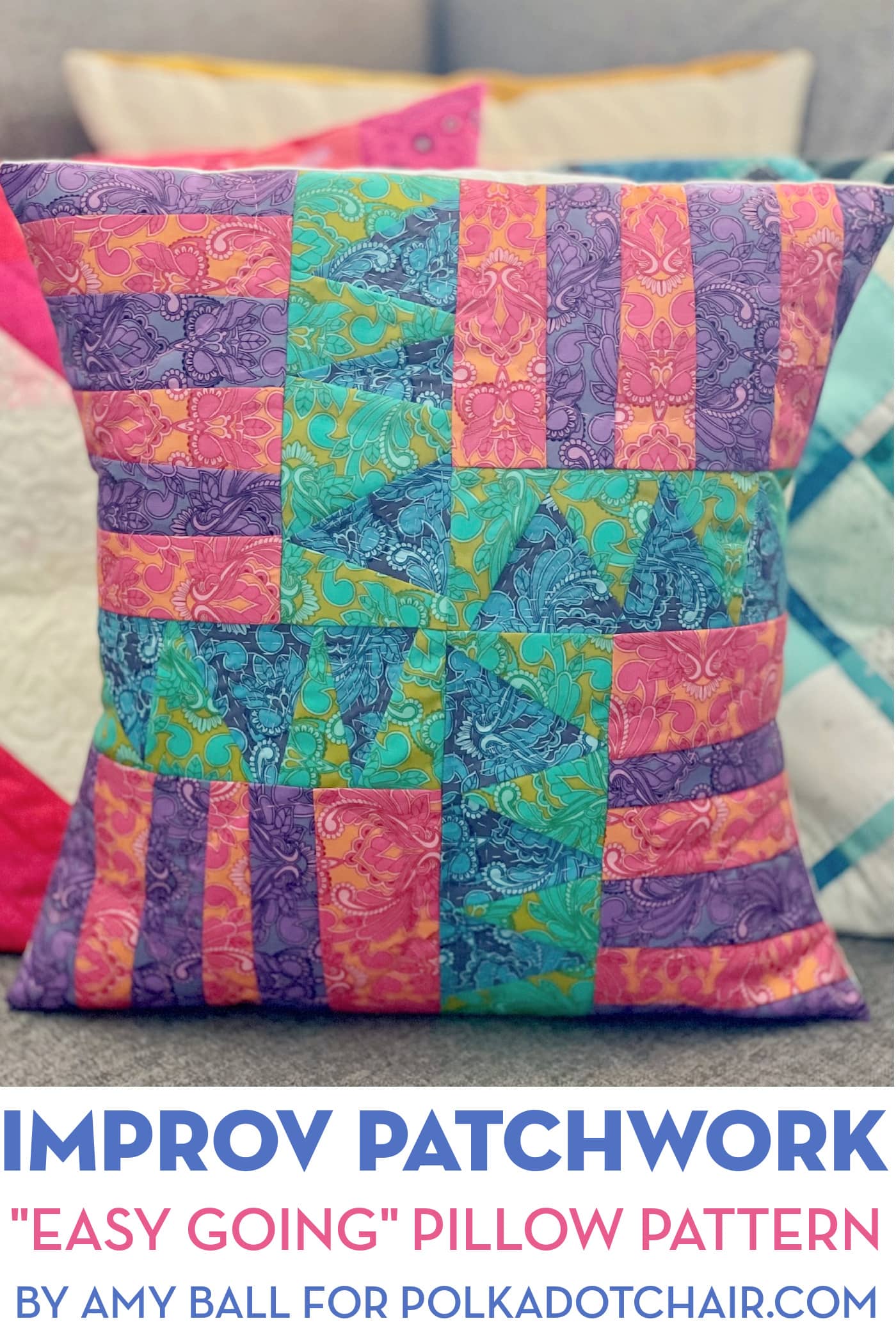 Blue, green, purple and red patchwork pillow on couch