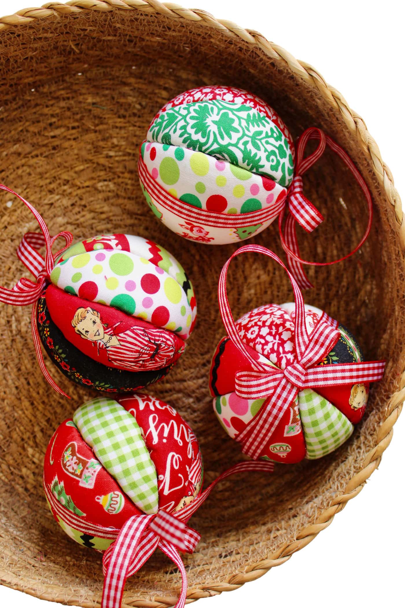 red, white and green fabric christmas ornament with bow in basket