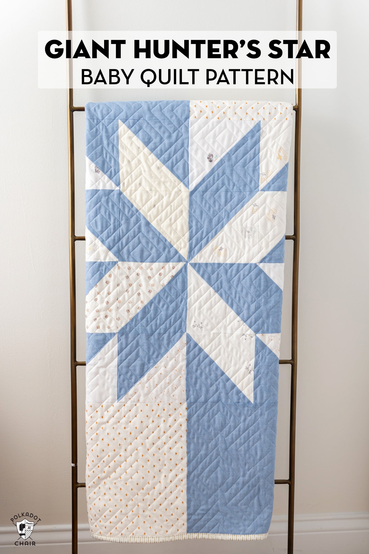 blue and white star baby quilt on quilt rack in white room