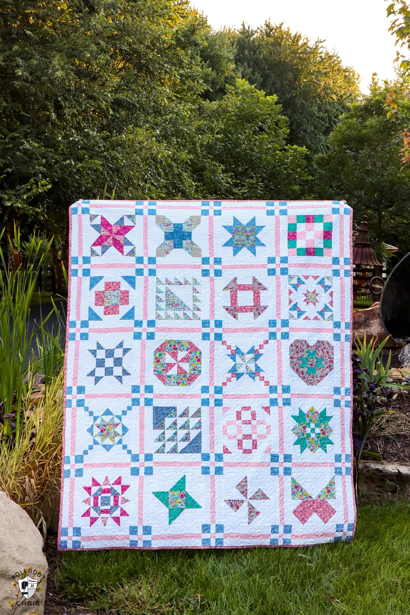 Blue, pink and white quilt photographed outdoors