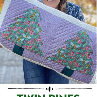 woman holding Purple and green pillow with patchwork pieced evergreen trees outdoors