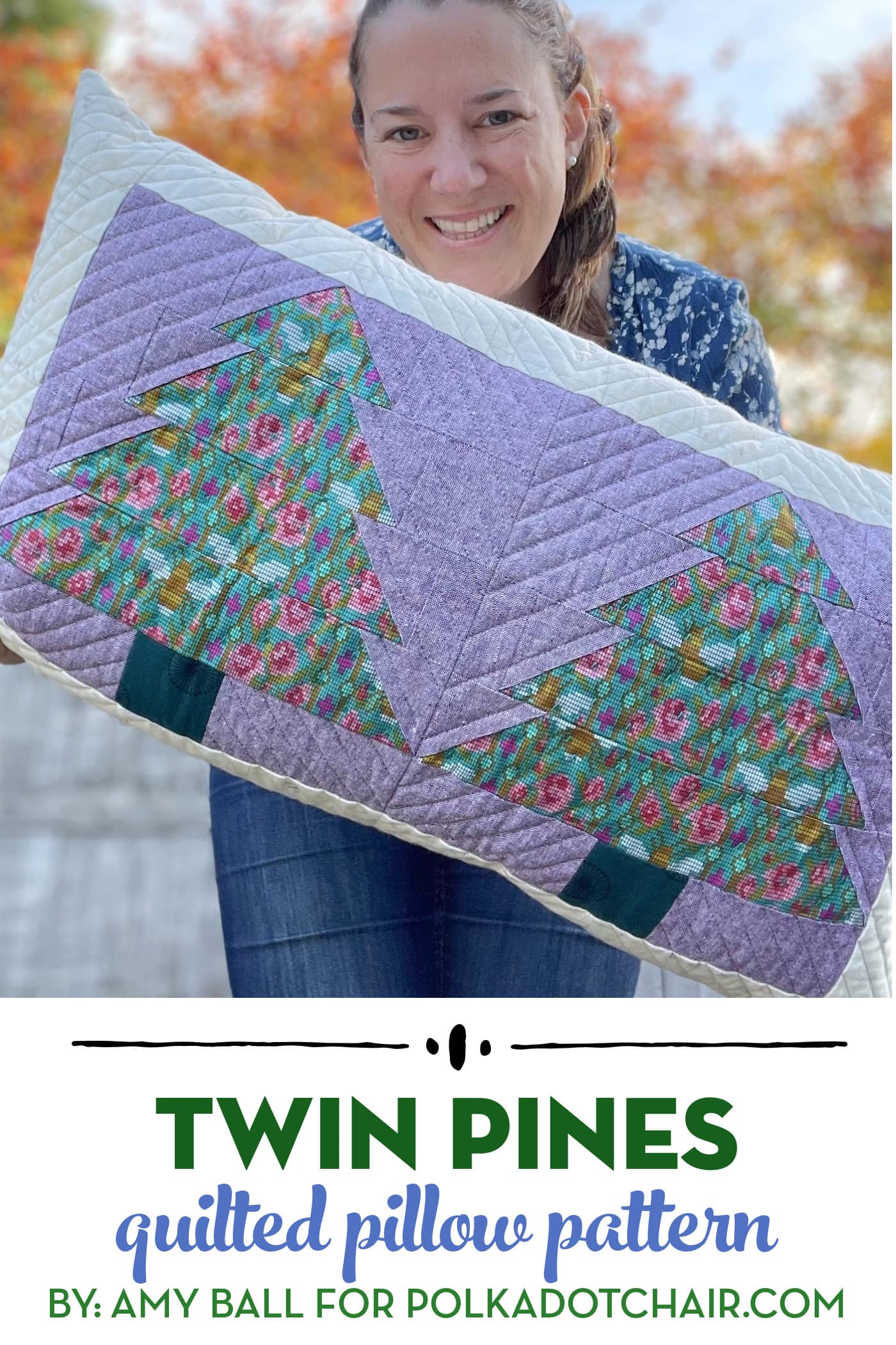 woman holding Purple and green pillow with patchwork pieced evergreen trees outdoors