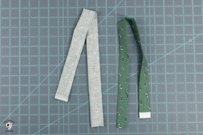 Two green rectangles of fabric on cutting mat