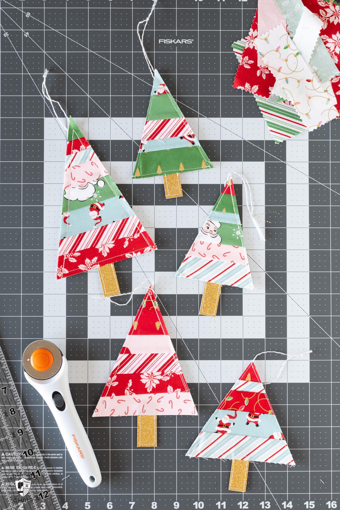 various christmas tree ornaments on gray cutting mat
