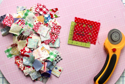 fabric scraps and ruler on pink cutting mat