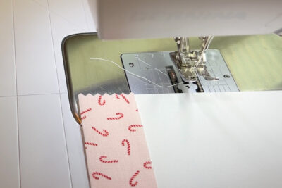 fabric strip and paper on sewing machine