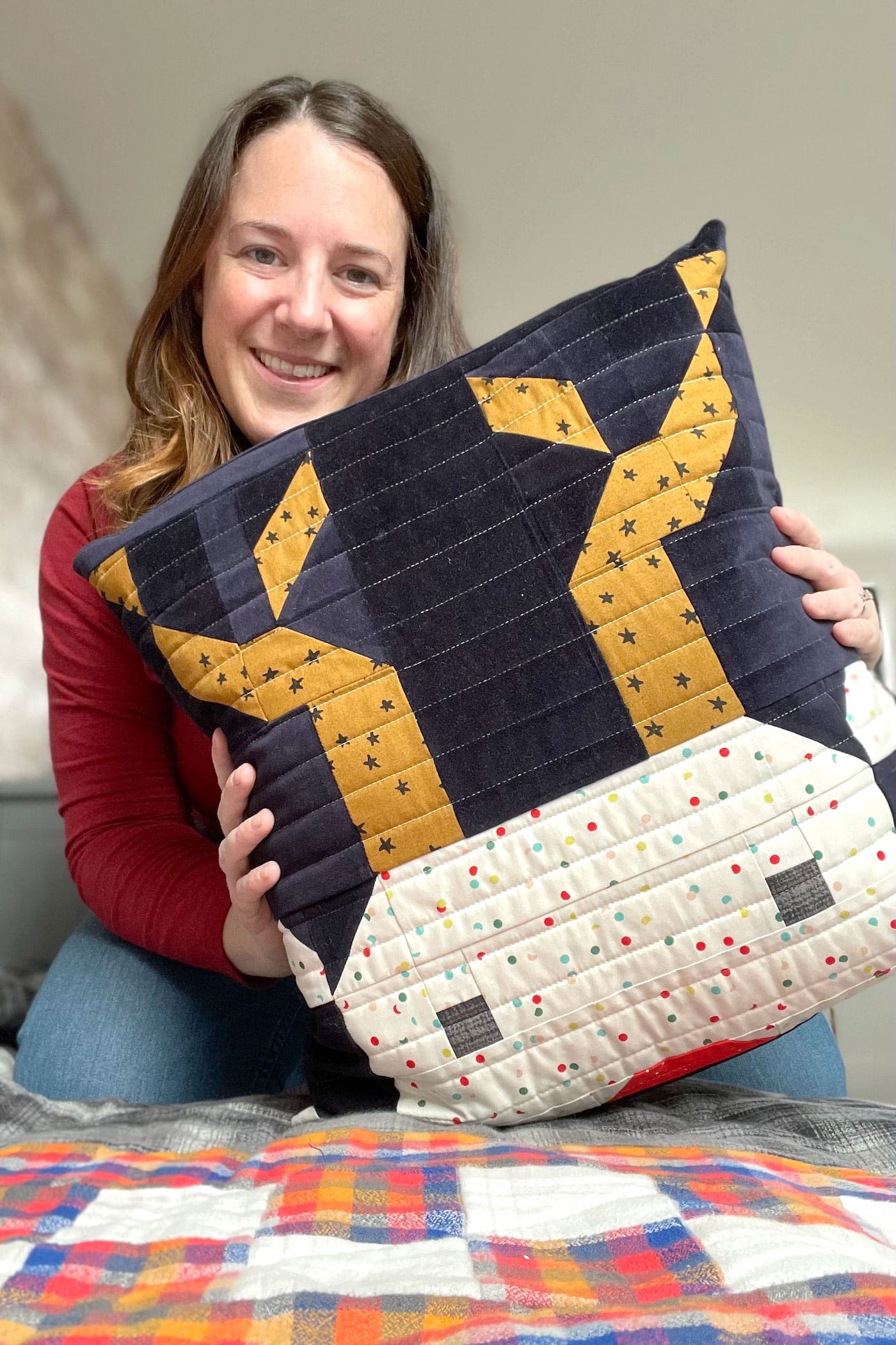 woman holding reindeer pillow