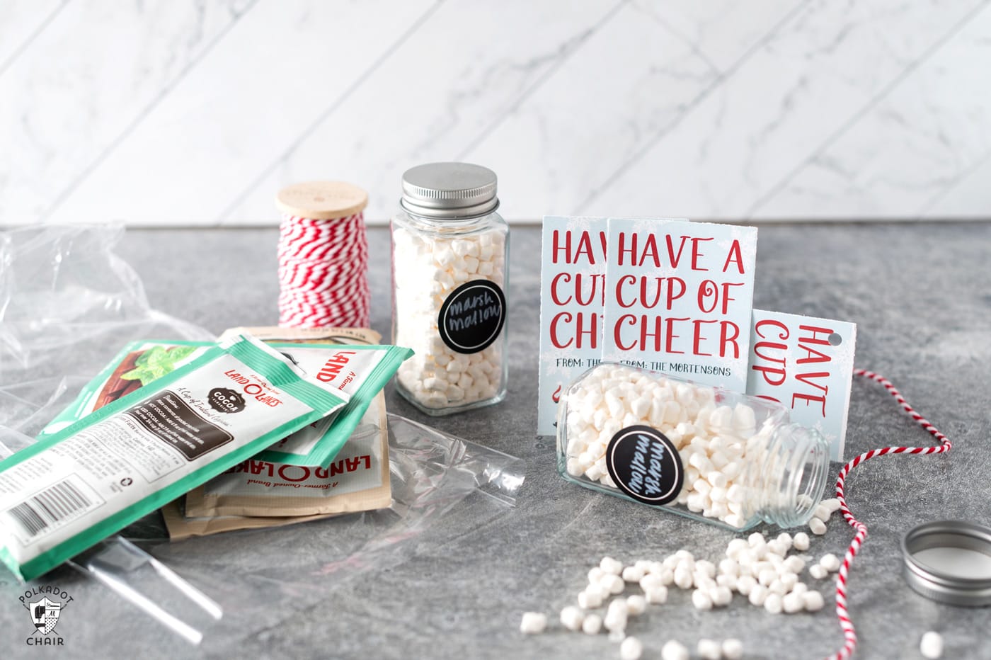 package of hot chocolate in a bag on a gray table with mini marshmallows